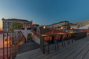 a balcony with a view of a city at dusk at Sapientia Boutique Hotel in Coimbra