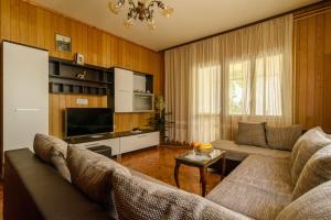 a living room with a couch and a tv at Trogir apartment Blaga in Trogir