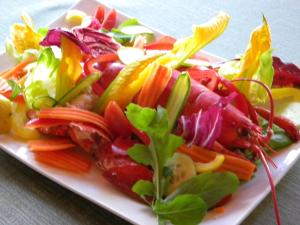 a white plate of vegetables on a table at Hotel Rosa Del Tirreno in Quercianella
