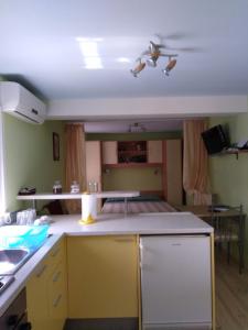 a kitchen with yellow cabinets and a ceiling at Apartment Ruza in Sali