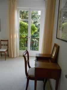 a room with a chair and a desk and a window at Chez Mamouska in Cassis