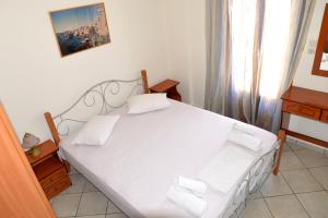 Posteľ alebo postele v izbe v ubytovaní Ifigenia Apartments