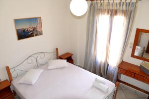Posteľ alebo postele v izbe v ubytovaní Ifigenia Apartments