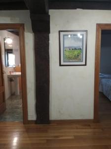 a room with a wall with a picture on it at Casa Batit in Viscarret-Guerendiáin