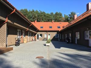 a courtyard of a building with a motorcycle parked in it at Namelis Preiloje in Neringa