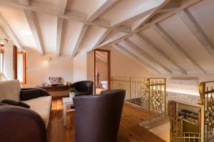 a living room with wooden ceilings and black chairs at Villa Guardian in Čilipi +40 photos