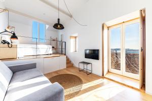 a bedroom with a bed and a tv and a window at Sapientia Boutique Hotel in Coimbra