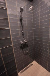 a shower with a phone on a tiled wall at Downtown beach apartments in Umag +27 photos