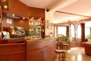 a bar in a restaurant with a counter and stools at Hotel Cristallo in Varazze
