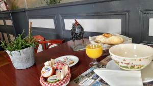 a table with a chicken sitting on top of a table at Logis Hôtel Le Relais Des Remparts in Allanche