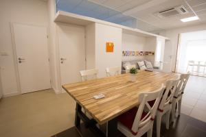 a dining room with a wooden table and chairs at Downtown beach apartments in Umag