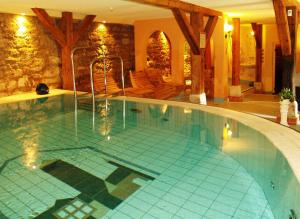 a large swimming pool in a hotel with at Hotel & Spa Wasserschloss Westerburg in Westerburg