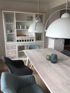 a dining room with a table and two chairs at Weststrandperle in Norderney