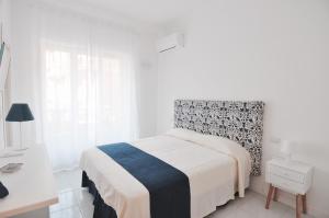 A bed or beds in a room at Iris Amalfi Dreams