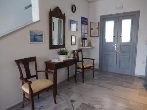 a dining room with a table and chairs and a mirror at Arkas Inn in Logaras