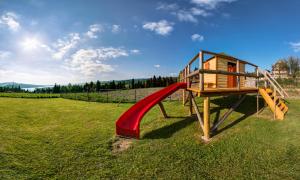 a playground with a red slide in a field at U Bochniaka in Czorsztyn
