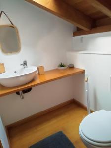 a bathroom with a sink and a toilet at Casa Pedra da Foz in Odeceixe
