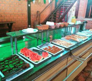 a buffet line with many different types of food at Estancia Montagner in Paulínia
