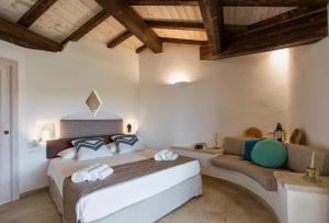 a bedroom with a large bed and a couch at Villa Nicoletta in Santa Teresa Gallura +96 photos