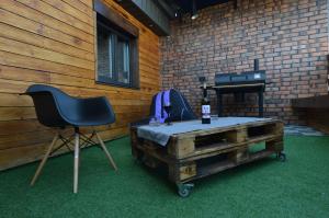 a room with a chair and a table and a stove at Air Loft Apartment in Kyiv