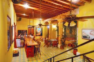 a restaurant with people sitting at tables in a room at La Brisa Loca Hostel in Santa Marta