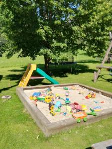 a sandbox with toys in the sand in a park at Sinsamreith, Familie Ensmann in Göstling an der Ybbs