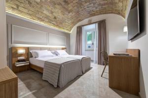 a bedroom with a bed with a stone ceiling at Magica Luna Boutique Hotel - Roma in Rome