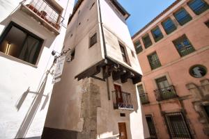 a building with a clock on the side of it at cuencaloft escapada al casco antiguo in Cuenca