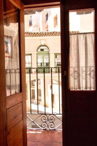 an open door with a view of a building at cuencaloft escapada al casco antiguo in Cuenca +3 photos