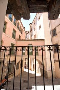 a view from the inside of a building through a gate at cuencaloft escapada al casco antiguo in Cuenca