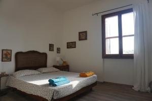 a bedroom with a bed with two towels on it at La Quercia Agriturismo in Imperia
