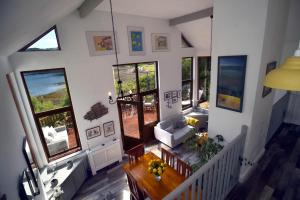 a living room with a table and some windows at Skye Photo Centre in Camastianavaig