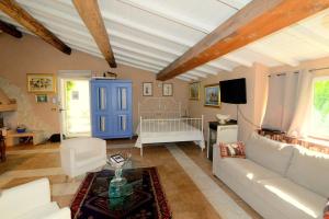 a living room with a white couch and a blue door at Podere Casanova in Pistoia