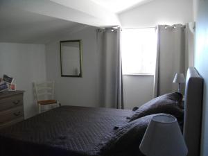 a bedroom with a bed and a window at Gite Les Deux Meules in Sainte-Colombe