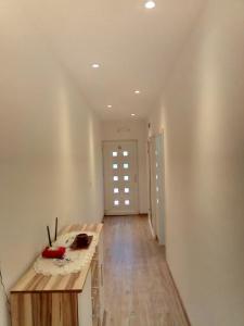 a room with a wooden table and a hallway at Apartment Luka in Makarska