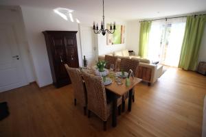 a dining table and chairs in a living room at Chalet Heidi in Rottach-Egern