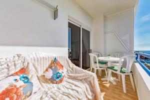a bedroom with a balcony with a table and chairs at Studio Overlooking The Ocean in Playa Paraiso