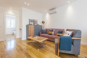 a living room with a couch and a table at Ana`s Houses in Guimarães