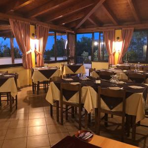 a restaurant with tables and chairs in a room at B&B Collemare in Drapia