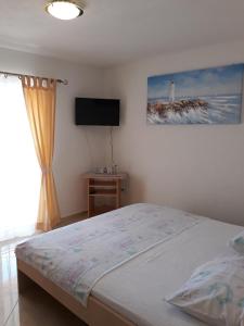 Postel nebo postele na pokoji v ubytování Apartmani Tanja