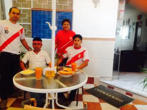 een groep mensen die naast een tafel staan bij Hotel San José in Piura