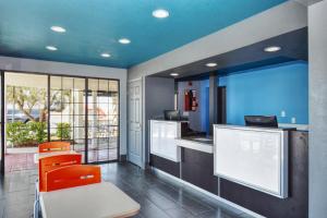 a kitchen with orange chairs and a blue ceiling at Vagabond Inn Buttonwillow North I-5 in Buttonwillow