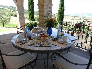 a table with plates and cups on a patio at Agriturismo La Casaccina in Trevinano