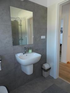 a bathroom with a sink and a mirror at Garden Baltic in Trzęsacz
