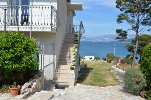 a stairway leading up to a house with a view of the ocean at Apartment A. Žižić in Slatine