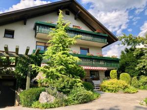 a building with a tree in front of it at HOMe apartments & Yoga studio in Bled-Rečica