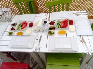 a white table with plates of food on it at Alya Mou Butik Hotel in Çeşme