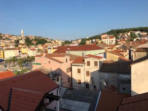 a view of a city with houses and roofs at BUGA apartment in center of Mali Losinj in Mali Lošinj