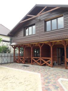 a large wooden house with a gambrel at Шале Озера in Melʼniki