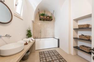 a white bathroom with a sink and a tub at Orazio33 b&b in Monopoli +117 photos
